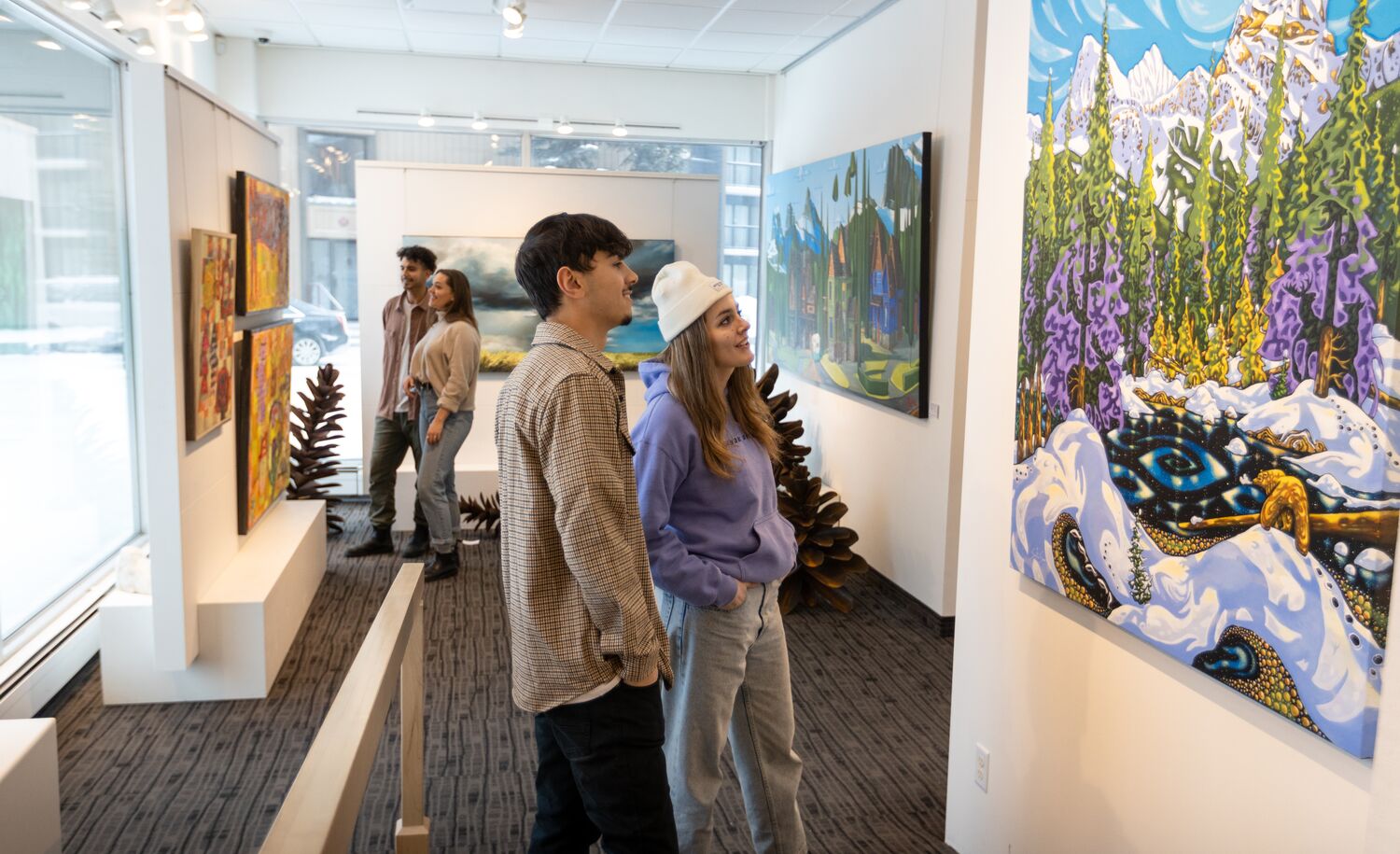 Friends explore the Canada House Gallery on Bear Street in the Banff Townsite.